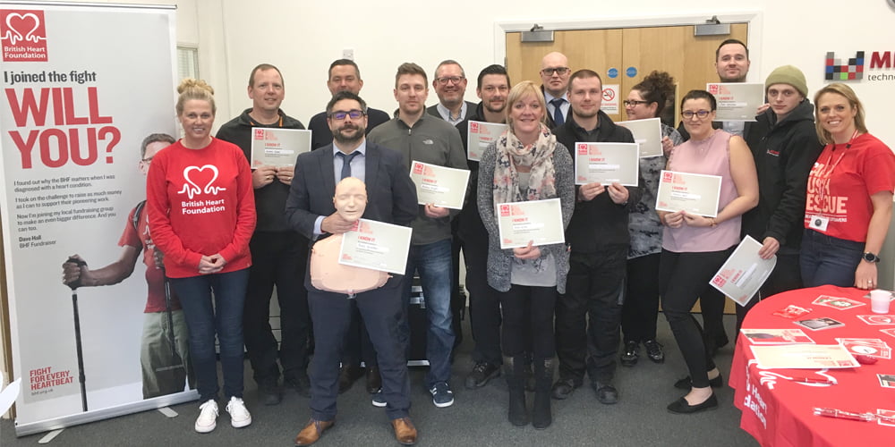 Group shot of Midshire staff with British Heart Foundation CPR training certificates